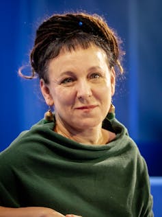 A woman in a shawl with a short fringe.
