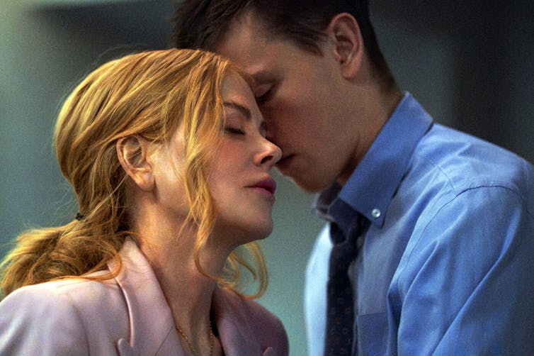 Nicole Kidman in Babygirl, leaning in to kiss her younger intern.