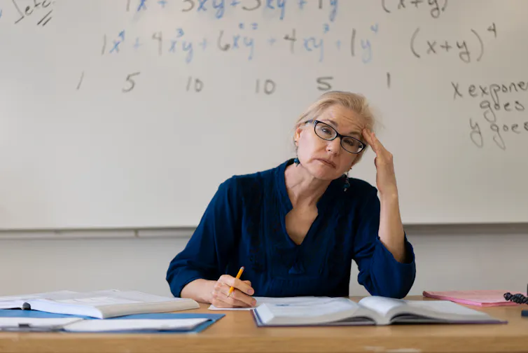 Woman sat in classroom looking stressed