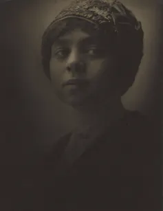 Sepia portrait of young woman with tight-fitting knit hat.