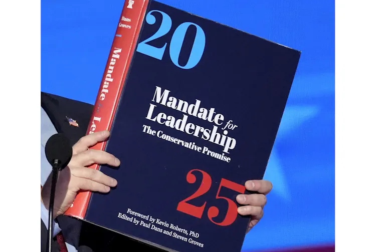 A large book with '2025' and 'Mandate for Leadership' printed on its cover.