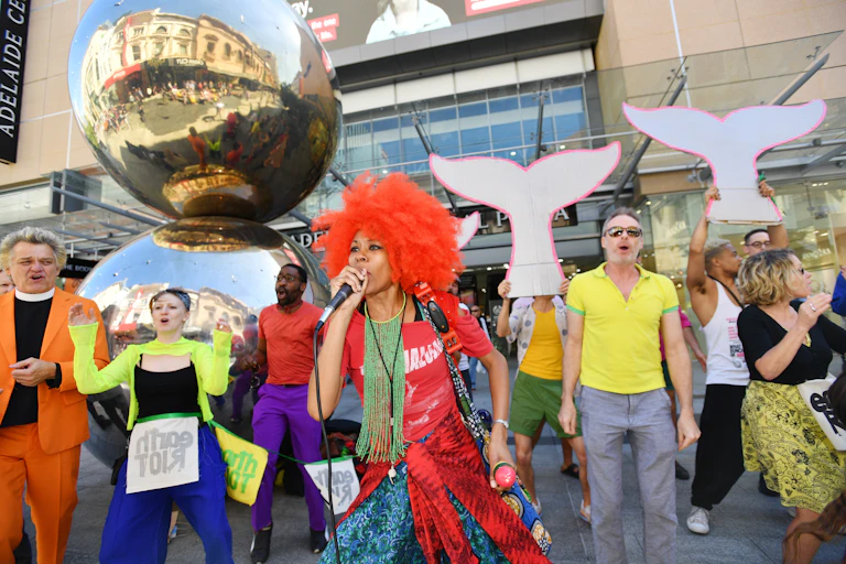 colourfully dressed people mount a protest