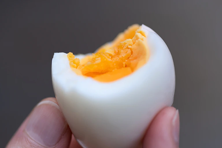 Close-up of a perfect boiled egg with a bite taken out of it.