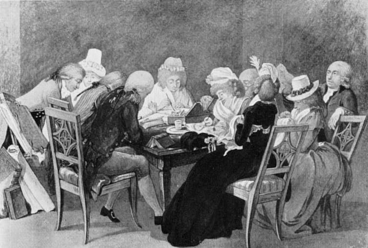 People sitting around a table in discussion.