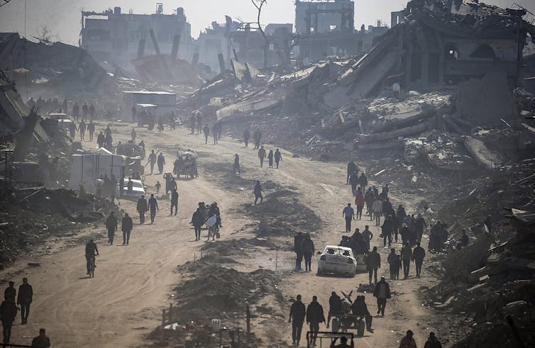 How Trump’s recommendation to ‘clean out’ Gaza despatched shockwaves throughout the Center East 1 Palestinians walk among the rubble of destroyed buildings.