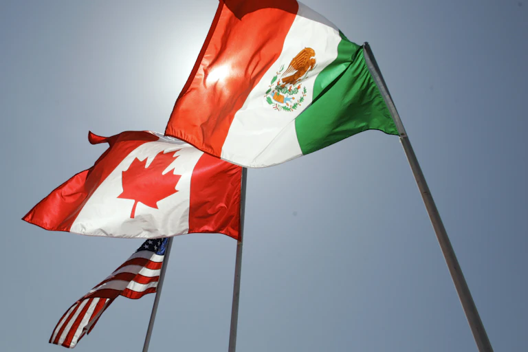 National flags representing the United States, Canada, and Mexico