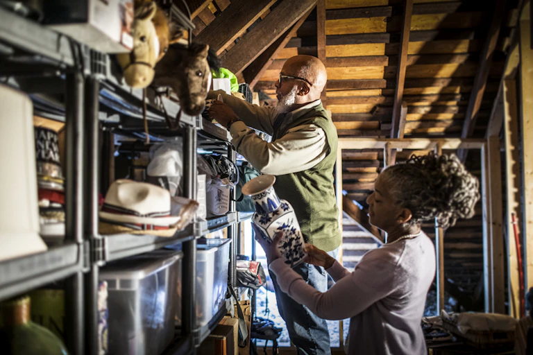 Senior couple organizing items in home attic