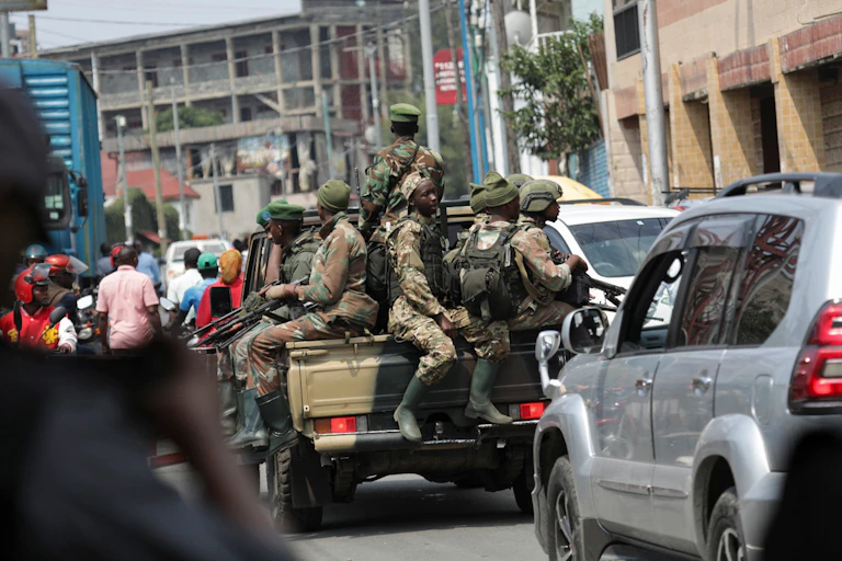 Members of the M23 armed group on the back of a pickup truck.