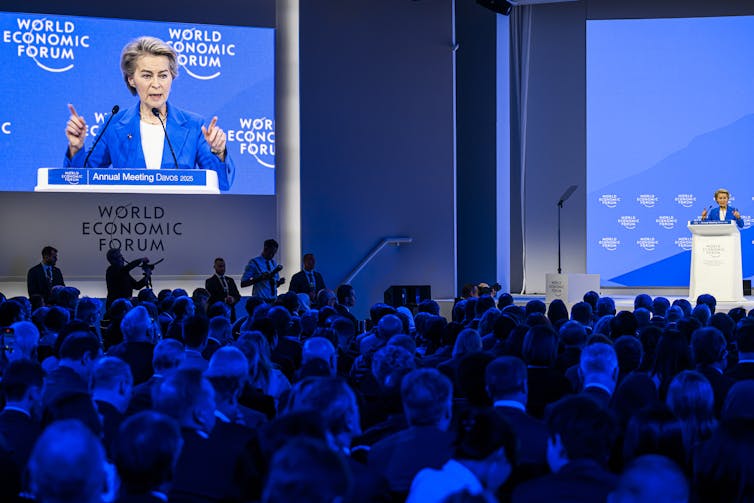 Ursula von der Leyen giving a speech in front of a crowd at Davos.