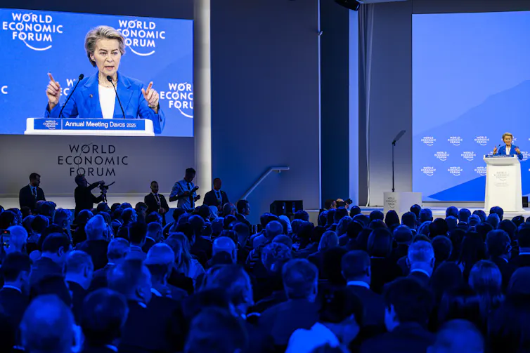 Ursula von der Leyen giving a speech in front of a crowd at Davos.