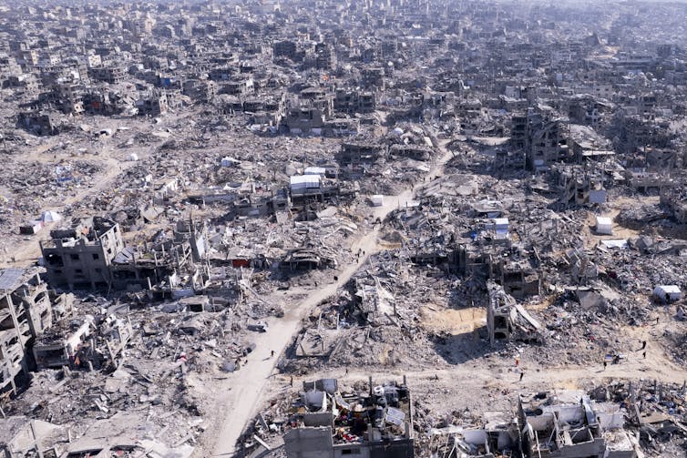 An aerial photo shows an expanse of massive destruction.