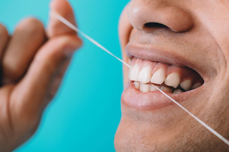 Person flossing their teeth.