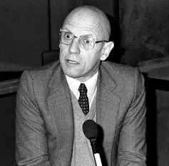 A bald man in a suit and tie.