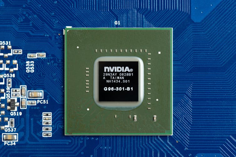 Close-up image of a black computer chip in a blue panel.