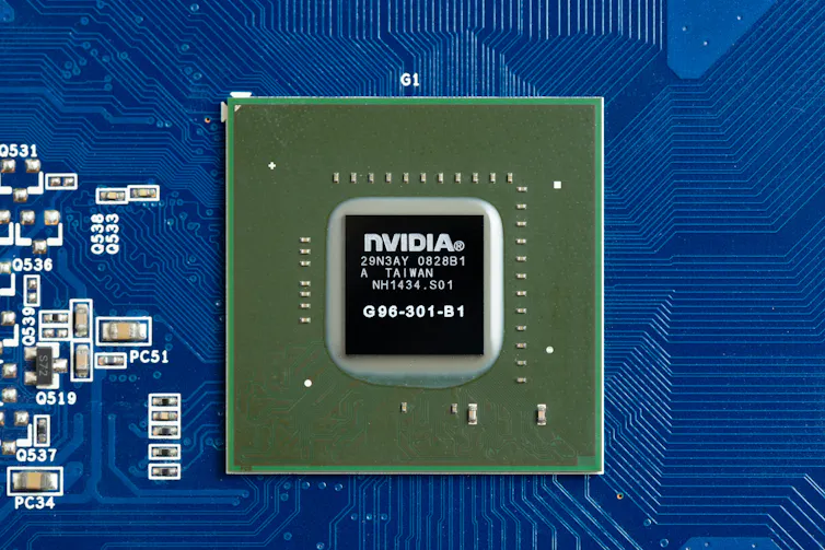 A close up image of a black computer chip on a blue panel.