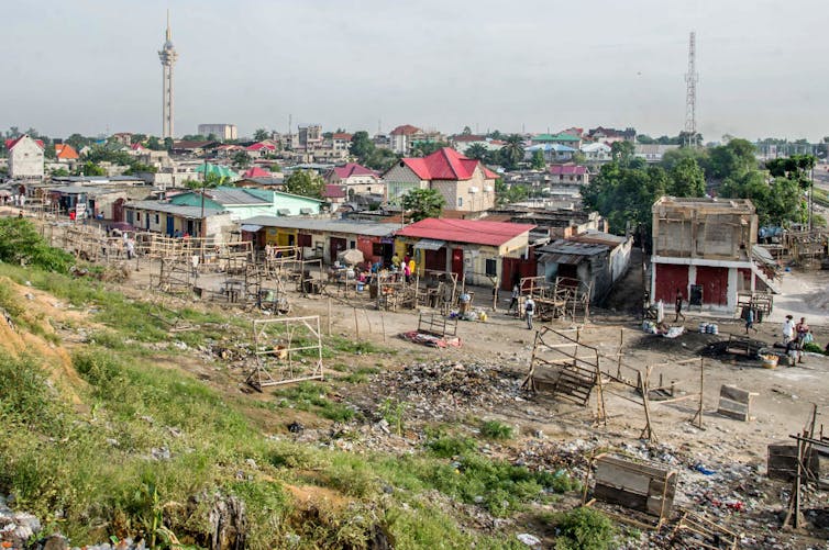 A view of a city with rundown shops at the outskirts.