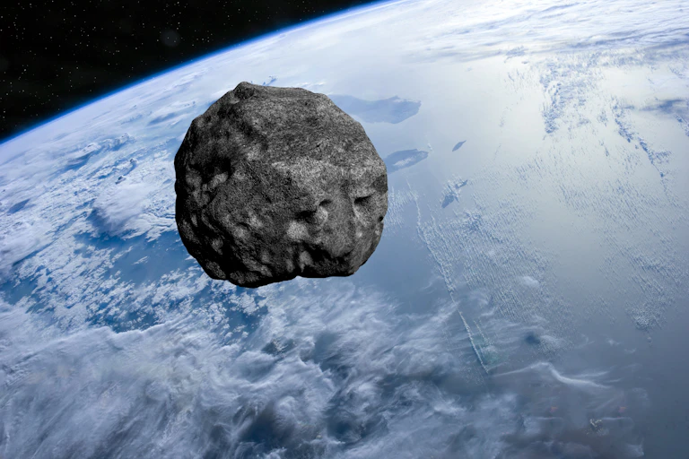 Illustration showing a large space rock with Earth in the background.