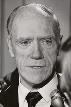 Black and white photo of a balding white man