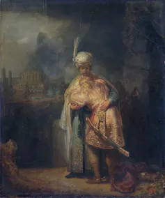 A painting in muted colors of one man with a turban embracing another man who has collapsed on his chest.