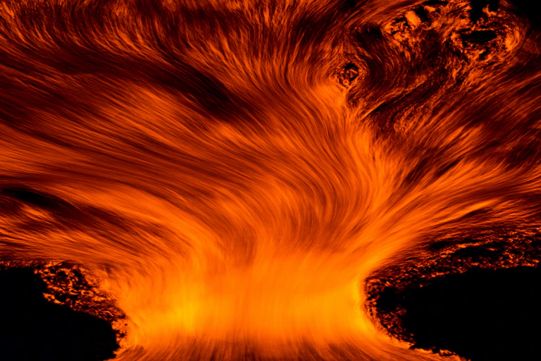Fire spreading against a black background.