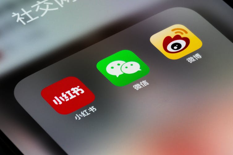 An iPhone screen showing three Chinese social media apps