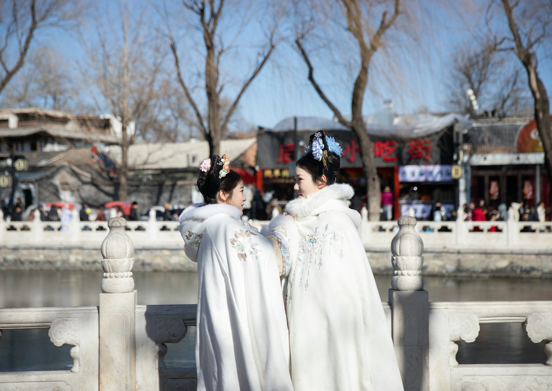 Two women dressed in traditional costume celebrate lunar new year in Beijing.