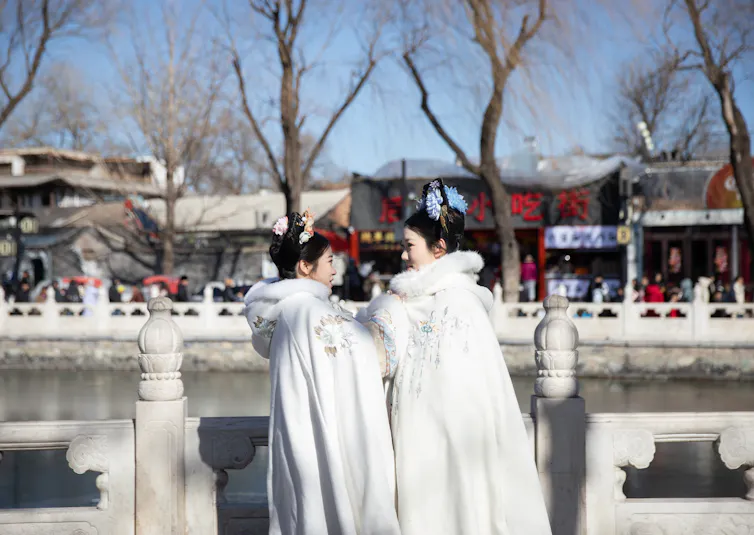 Two women dressed in traditional costume celebrate lunar new year in Beijing.
