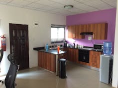 The inside of a house with a kitchen door and tiled floor