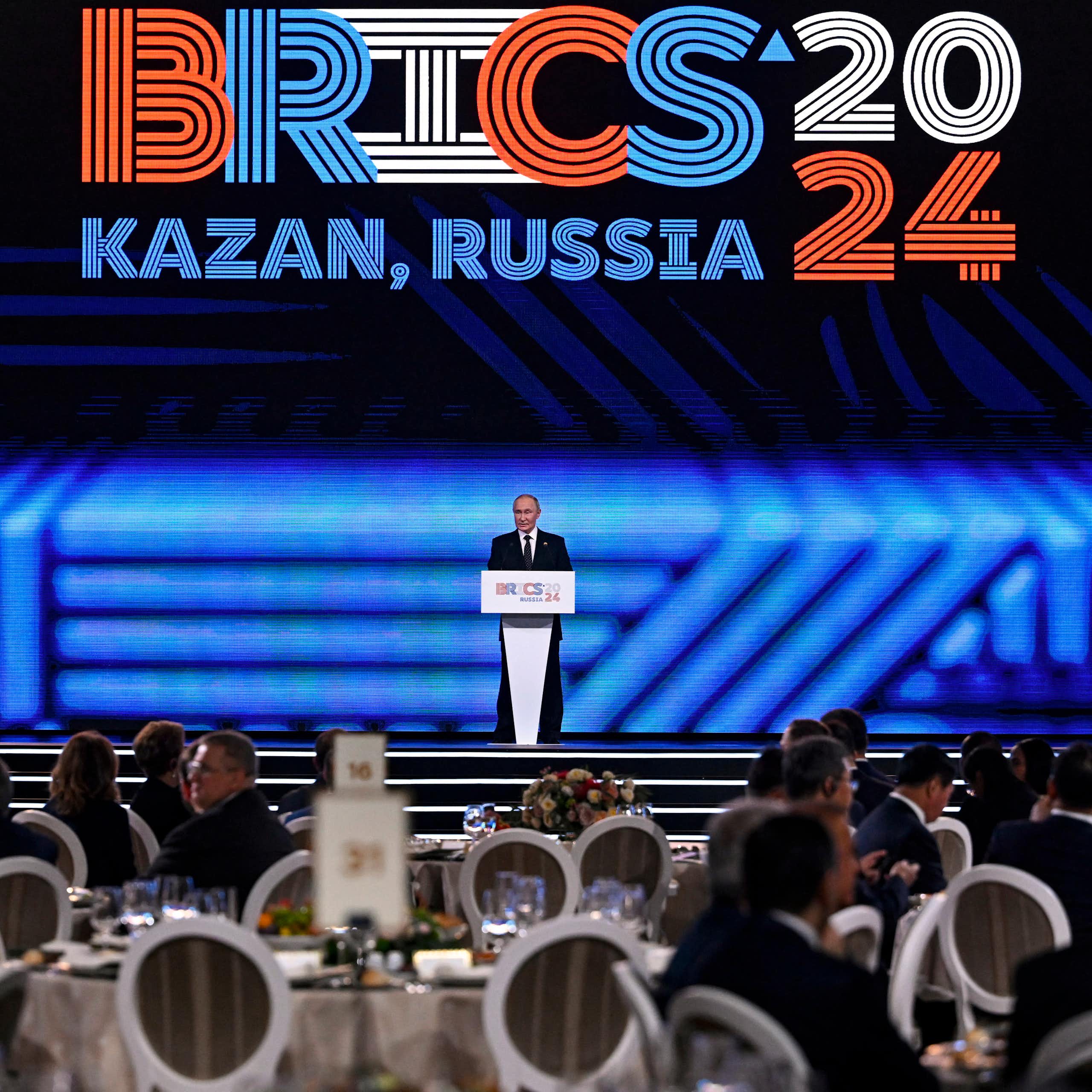 A man in suit addressing a large gathering