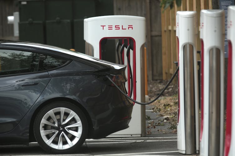 Back end of a car plugged into an electric vehicle charger