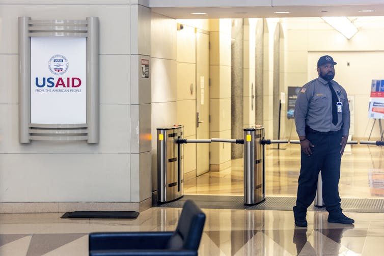 A security guard stands at a checkpoint in the USAID offices.