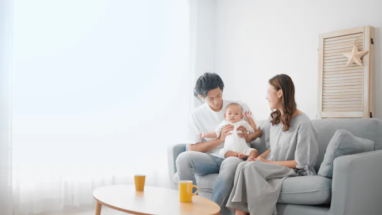 Parents comforting their child at home