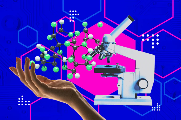 Human hand holding molecular structure next to microscope.