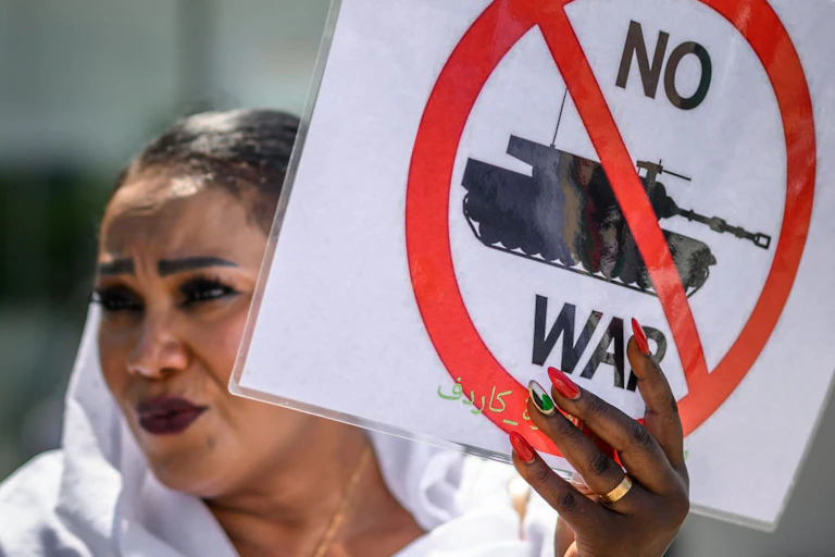 A woman holds an anti-war placard during a demonstration