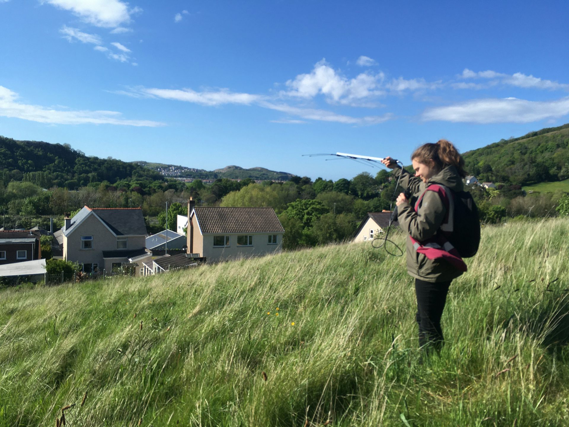 A person on a hillside with an aerial.