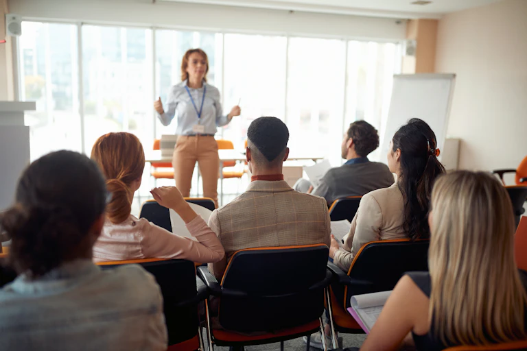 Woman standing in front of class of adults