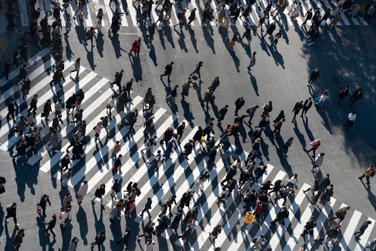 Pedestrians crossing a busy intersection.