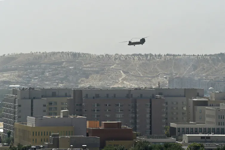 A helicopter flies above a city.