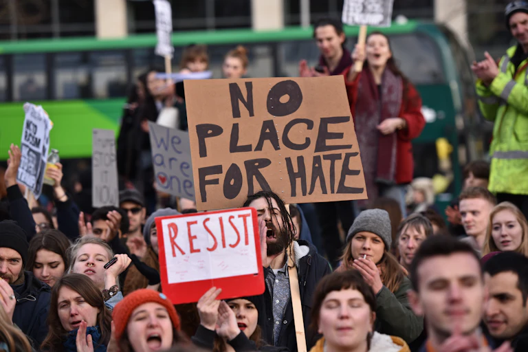A protest with a large sign that says no place for hate