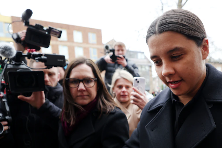 Sam Kerr dodges journalists as she arrives at her UK trial