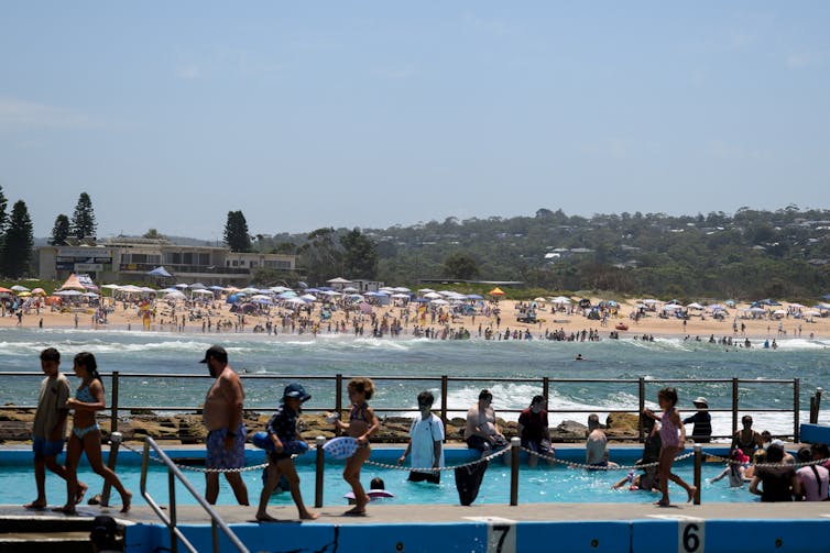 people cooling off at the beach