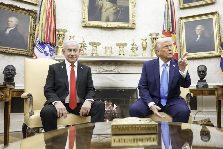 Donald Trump sits alongside Benjamin Netanyahu in the White House while talking with journalists.
