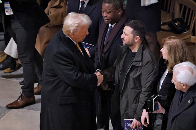 Donald Trump shakes hands with Volodymyr Zelensky at the reopening of Notre Dame cathedral in Paris, December 2024.