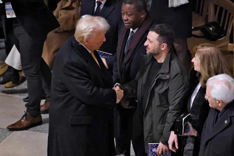 Donald Trump shakes hands with Volodymyr Zelensky at the reopening of Notre Dame cathedral in Paris, December 2024.