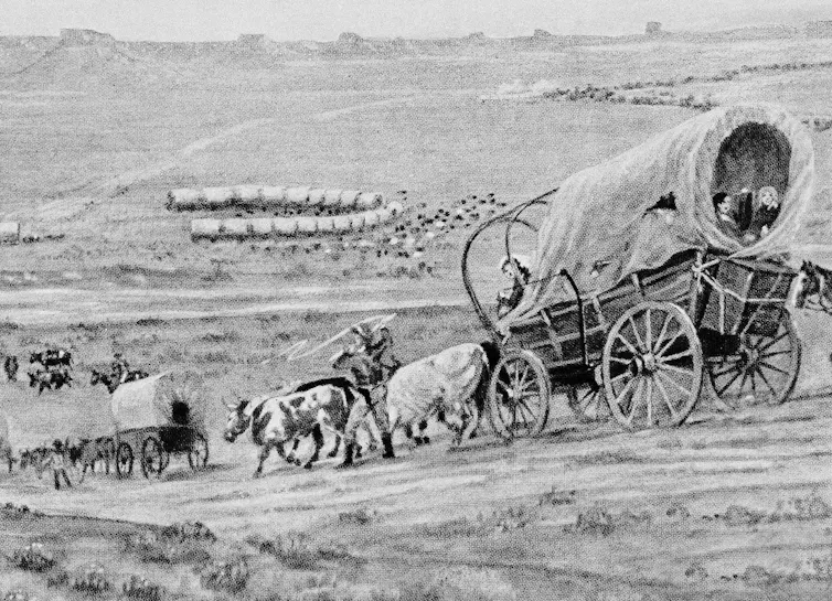 Artwork shows oxen pulling a covered wagon on a plain.