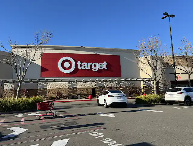 The facade of a Target store with bold red signage and a parking area are visible on a clear day in San Ramon, California.