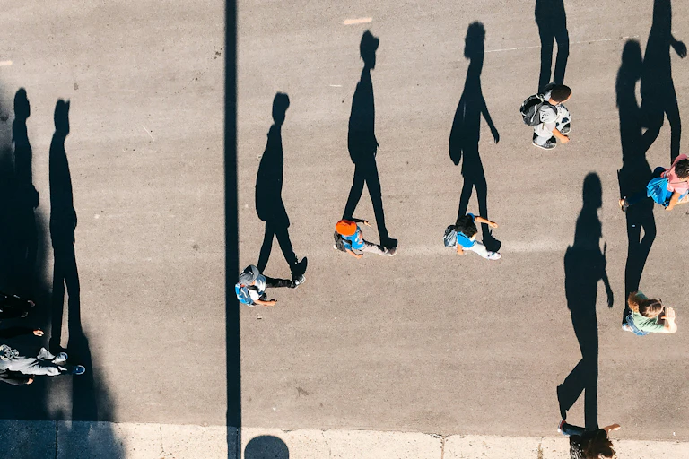 people photographed from above with their shadows