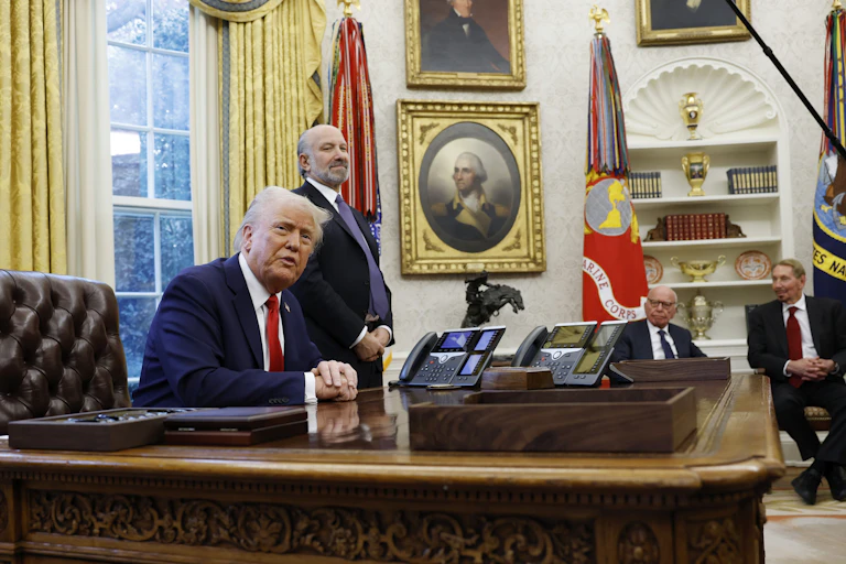 U.S. President Donald Trump speaks to reporters in the Oval Office.
