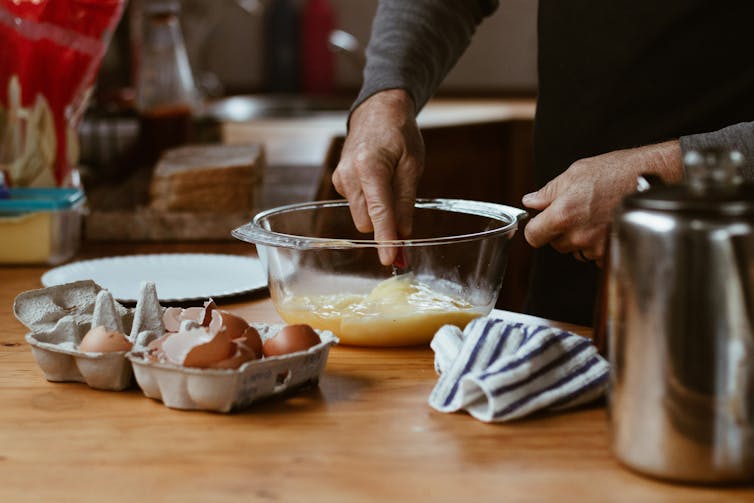 Man whisks eggs