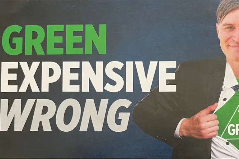 A political ad showing a man ripping his shirt open to reveal a Greens t-shirt underneath